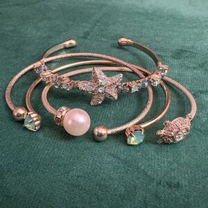 Collection of 4 Ocean Themed Gold Tone Cull Bracelets